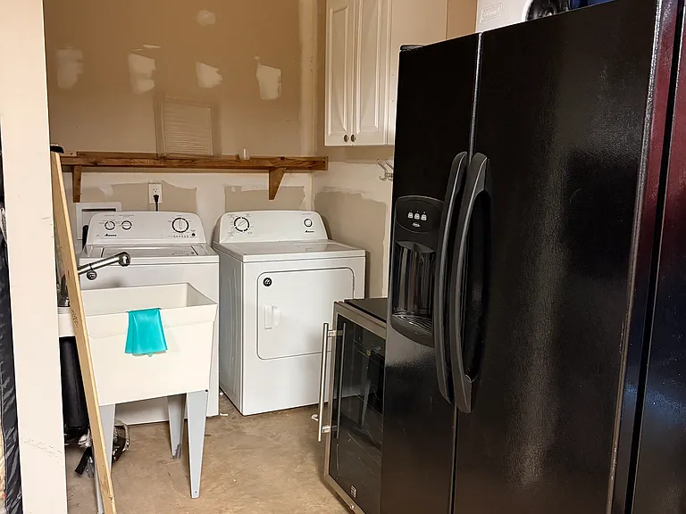 Washer/Dryer and full sized fridge located on the first floor (inside the garage space)