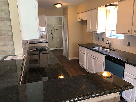 Brand new granite counter tops, black dishwasher, electric stove, kitchen sink and faucet and new wall oven