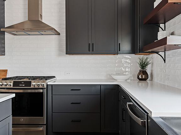 Subway tile backsplash with stainless steel hood