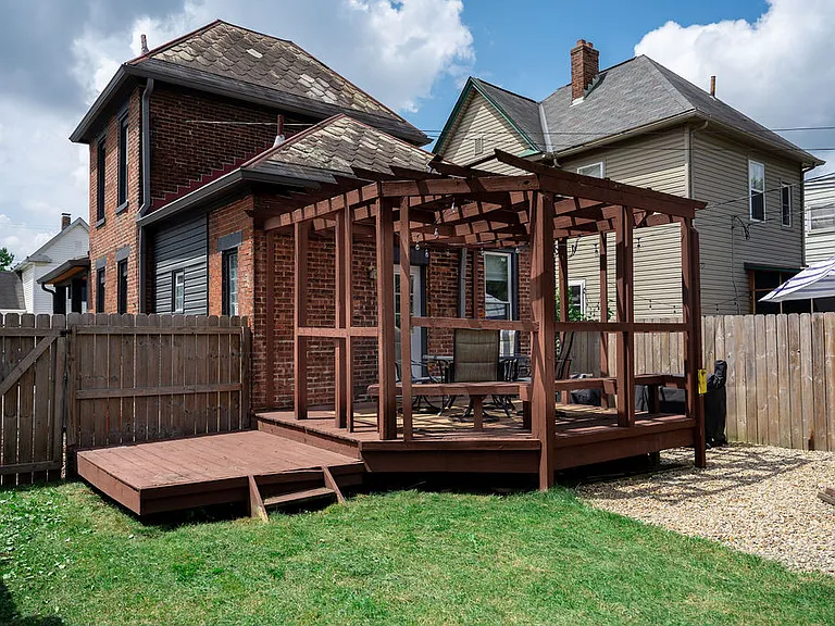 Fenced in backyard w/ deck