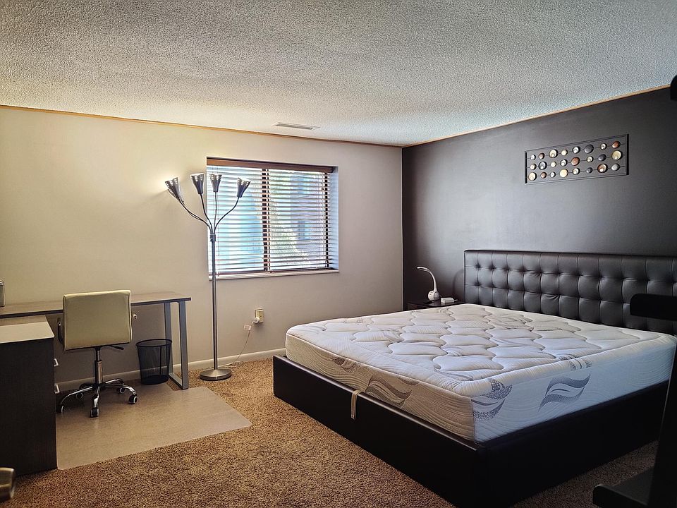 Master bedroom with king size bed. Bed has storage space underneath.