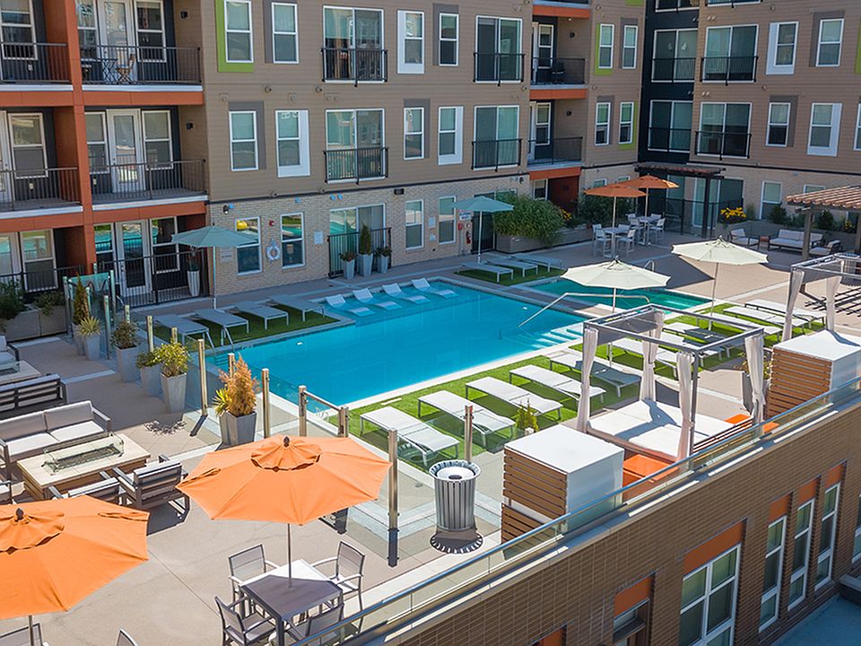 Resort-style outdoor lounge area, swimming pool, and grilling stations
