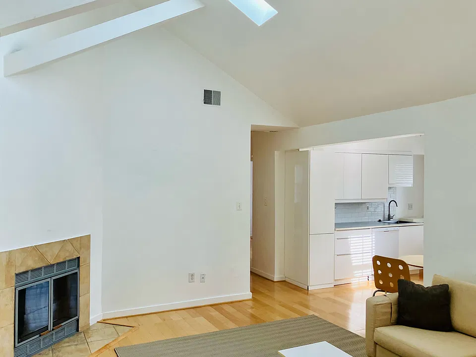 Living Room Wood Burning Fireplace and Kitchen