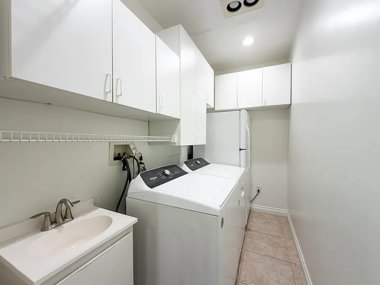 Convenient laundry room with washer, dryer, and utility sink adds everyday ease to this Beverly Hills luxury rental home at 1094 Garden Lane, ideal for a 90210 lease.