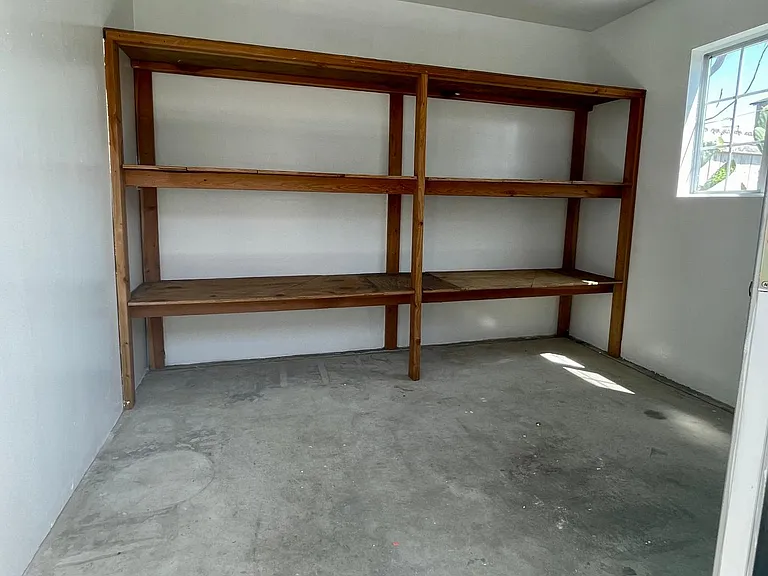 Detached Storage Unit on side of house.