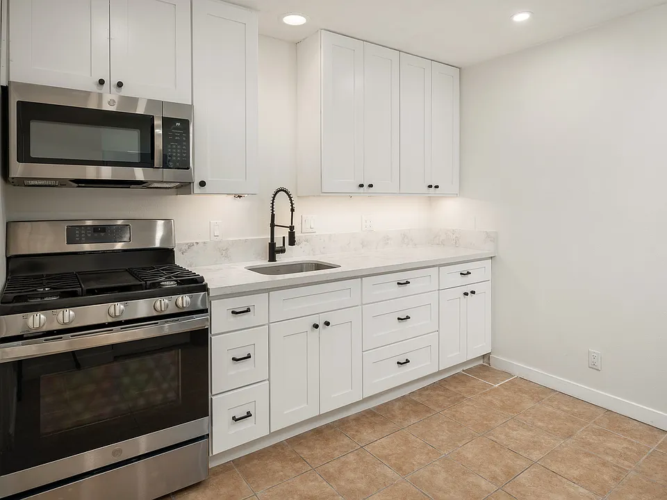 Brand new kitchen cabinets, stainless steel appliances, quartz countertops and under-cabinet lighting.