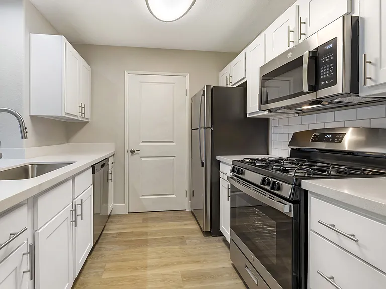 Featuring sleek stainless steel appliances, including a spacious refrigerator and a convenient dishwasher, these kitchens are designed for both cooking and entertaining.