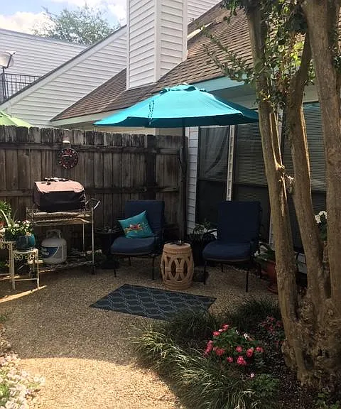 Back patio with privacy fence. Carport in rear.