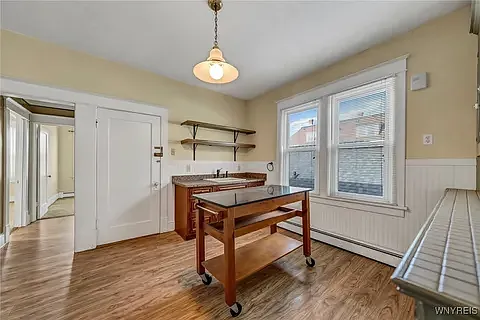 Bright and spacious kitchen, with moveable granite Island, open shelving.