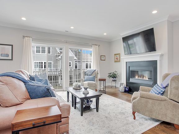 Bright living room with fireplace and sliding door to deck