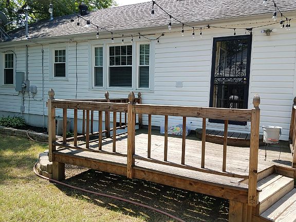Custom built wood decking. Great for cookouts in the back yard! Strung lights as well.