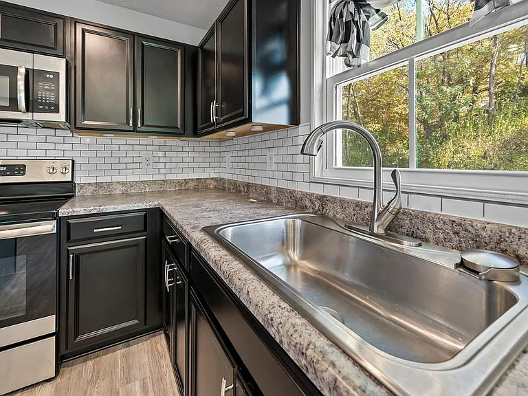 White Subway Tile Backsplash and Dark Espresso Cabinets. Plus Above and Under Cabinet Lighting with Remote!