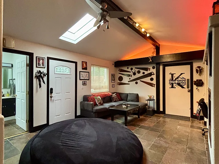 Shared den with fireplace, tv, couch, giant bean bag, wet bar
