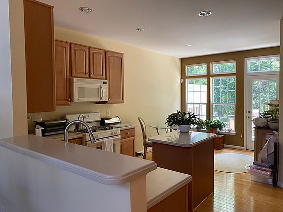 Eat in kitchen that looks out onto woods. Wood floors.