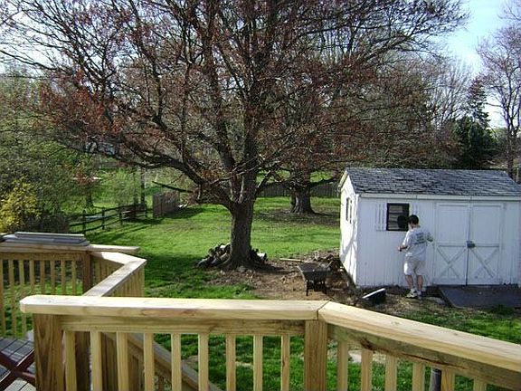 Large fenced rear yard with mature trees