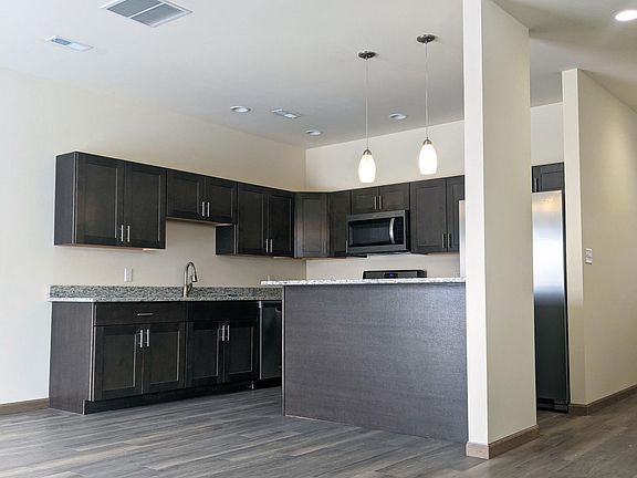 Kitchen & Living Area With Beautiful Laminate Grey Wood Flooring.