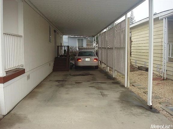 Carport noting back entrance and please note the private screen setup.