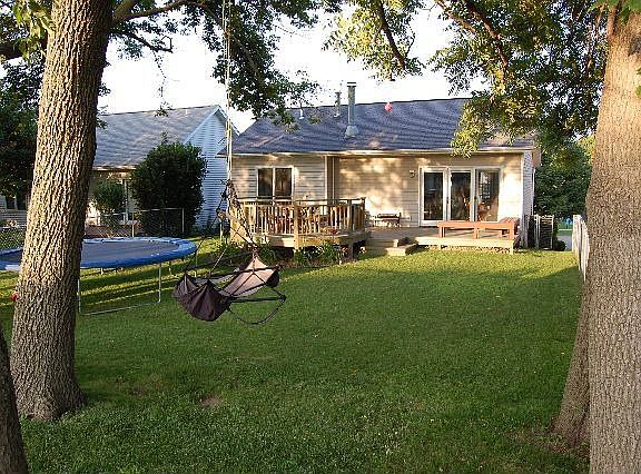 Large fenced backyard with mature trees