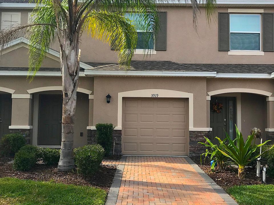 Beautiful exterior view of the front of the townhouse with a single car garage and driveway
