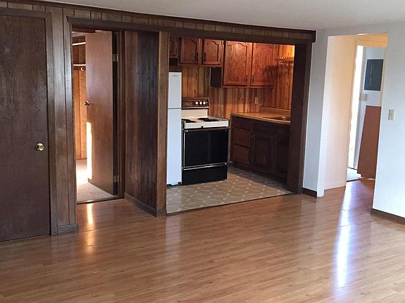 View from living room to bedroom 1 and galley kitchen.  Hall