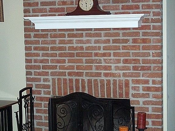 Floor to ceiling brick fireplace is wood burning.  Charming.