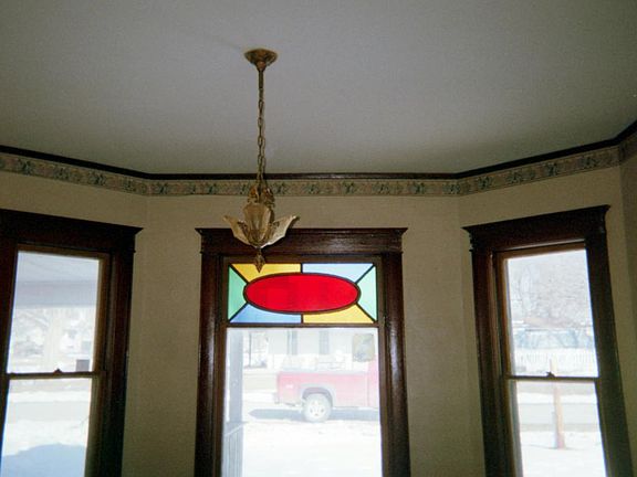 This picture gives a closer look at the windows on the north side of the house which faces the street. Stained glass and woodwork is original, real wood.