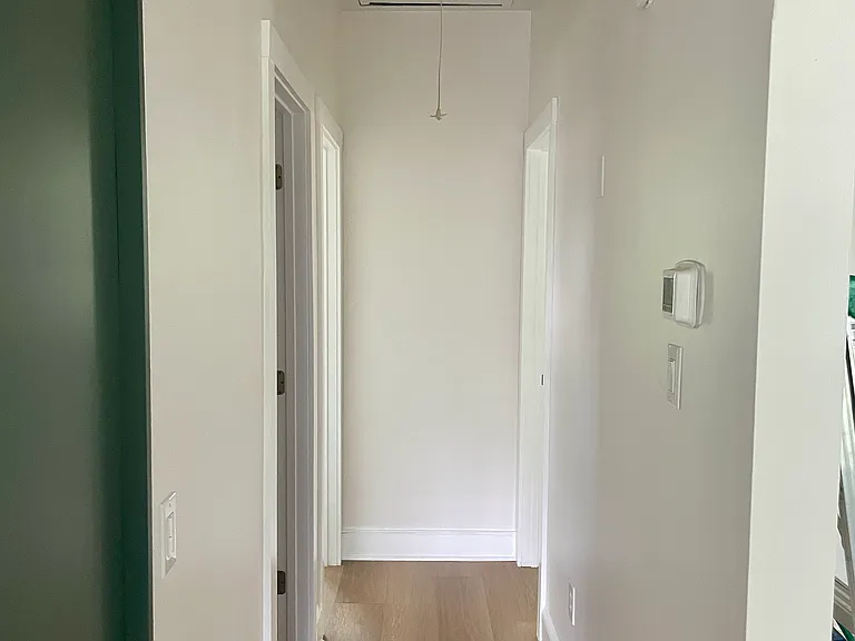 Hallway from the kitchen/living room down to the bathroom and two bedrooms.
