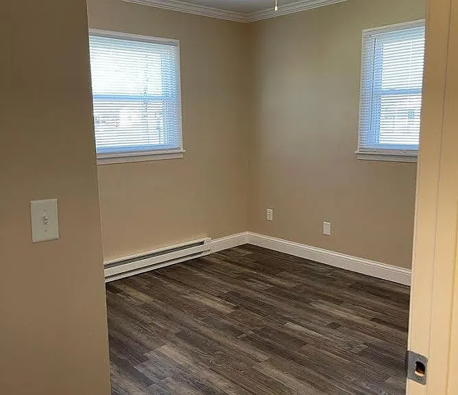 Bedroom 1 with ceiling fan new blinds and new baseboard heat