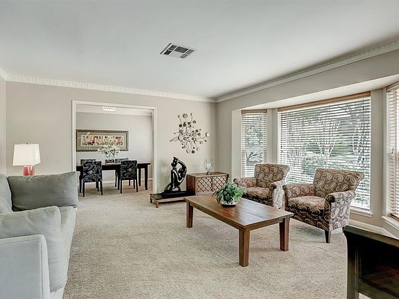 Formal dining and living areas include large bay window and crown molding.