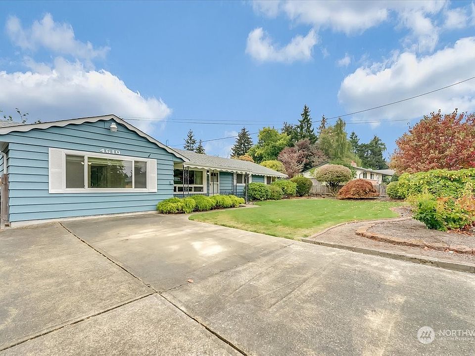A picture of neatness, this wonderful University Place rambler provides abundant parking & manicured landscaping on an oversized lot. >