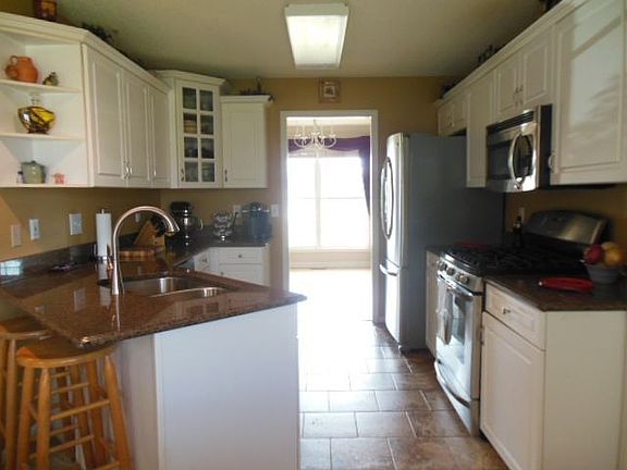 KITCHEN W/ GRANITE COUNTERS & TILE FLOORS