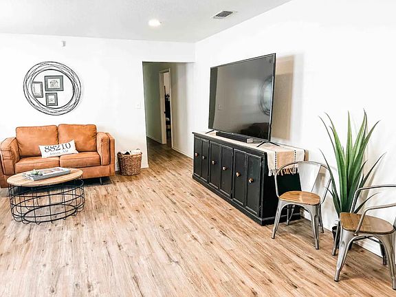 large open living room with two couches and large TV
