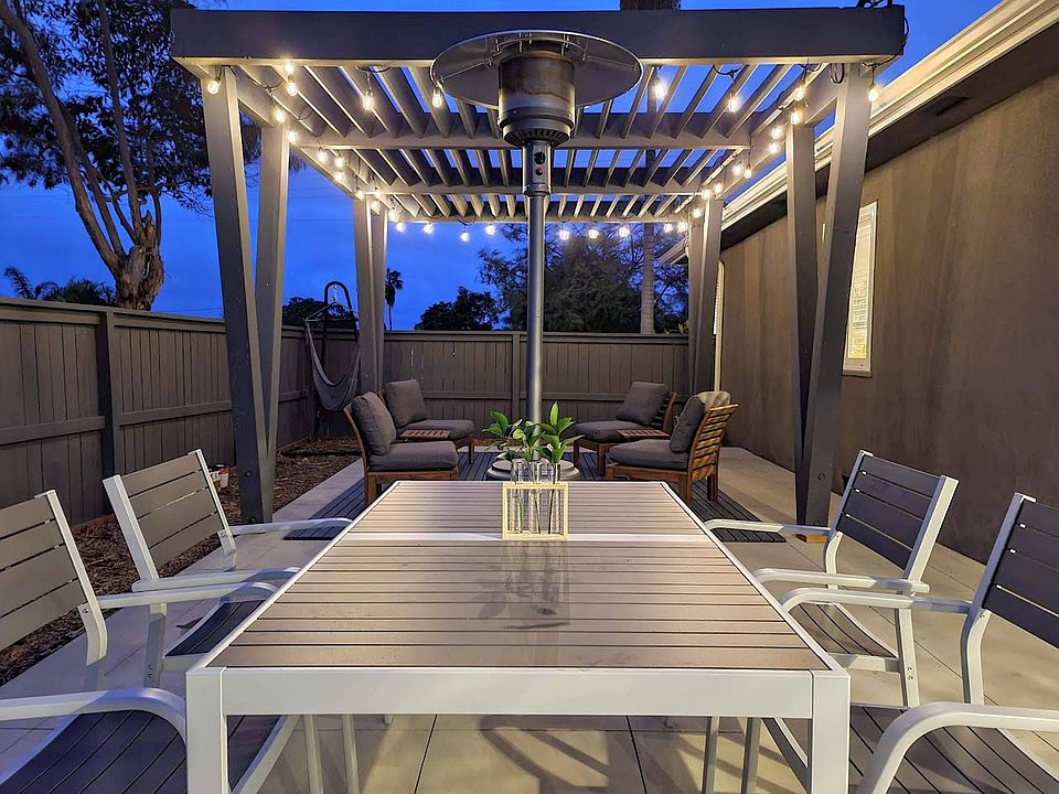 Backyard dining area, pergola with fireplace and fireworks view.