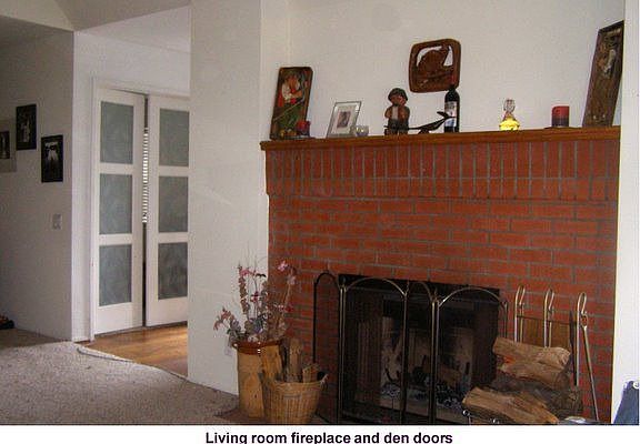 Cozy wood burning brick fireplace located in living room