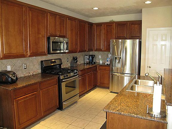 Delightful kitchen boasts gorgeous granite countertops and stainless steel appliances.