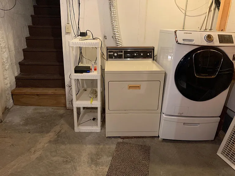 Laundry area and back staircase up to garage.