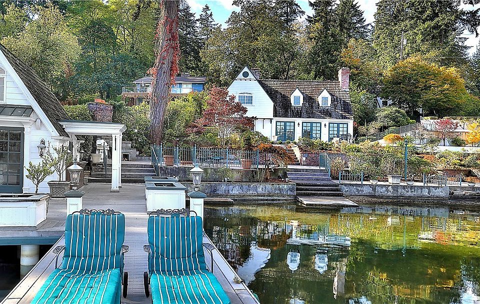 One of a Kind, Lake Steilacoom waterfront estate. 3 parcels, park like setting to include two large patio spaces, 2,300 sq. ft. main house, boat house with a loft and living room with gas fireplace. Detached garage with guest studio and large storage area.