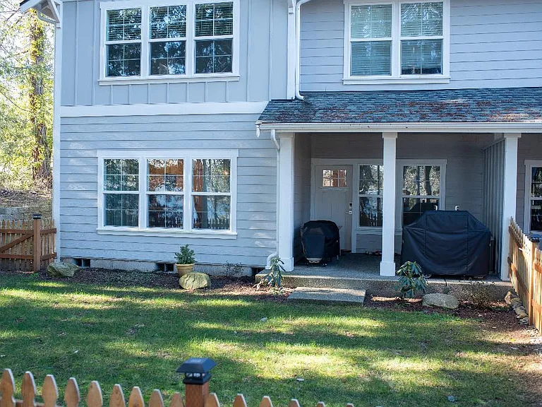 another view of back of home and covered deck