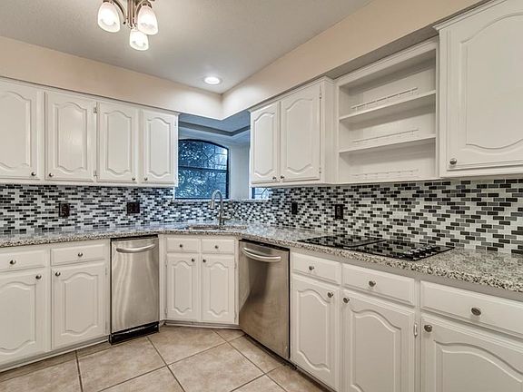 Glass back splash with granite counter tops.