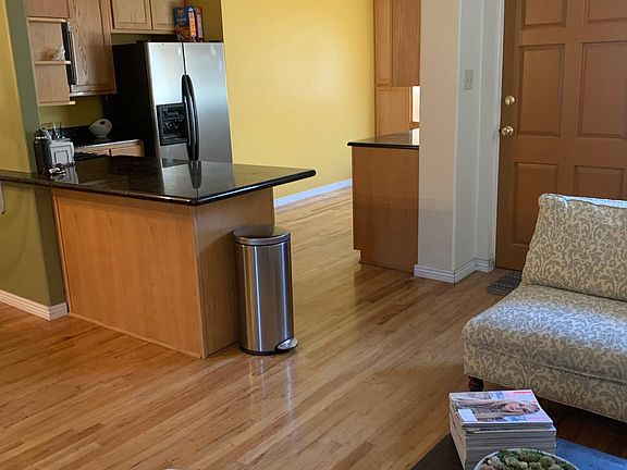 View into kitchen from additional seating area (adjacent to dining area).
