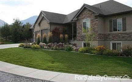Corner Lot
						:
						The front yard wraps around the side of the house, lined with trees on the west.