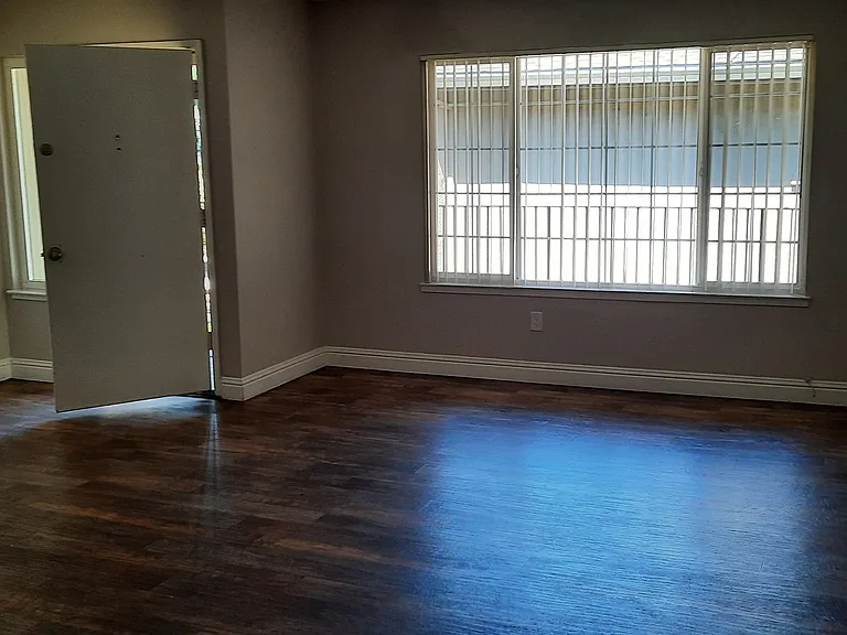 Some 2 bedroom units, the living room is also carpeted. The Vinyl Planking may also be a grey toned instead of brown.