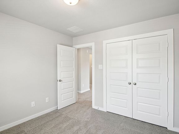 The bedroom of a home in Harper s Preserve of Conroe, TX.