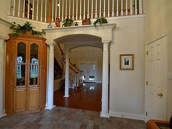BEAUTIFUL FROMAL ENTRY WITH COLUMNS, LARGE COAT CLOSET AND MULTICOLOR SOFT HUED TILE FLOORING.