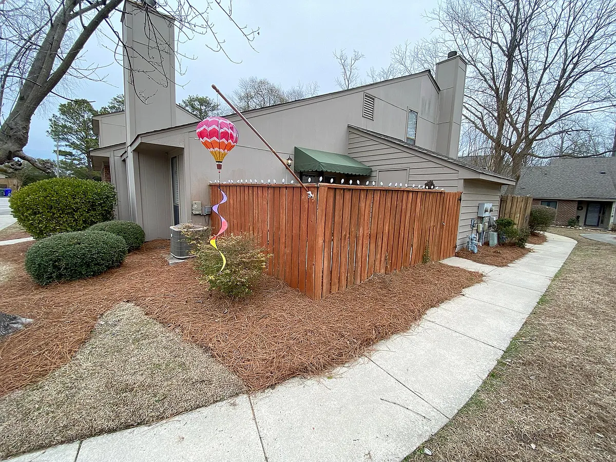 fenced patio with storage area for bikes and gardening supplies. - 111D Sunshine Ln