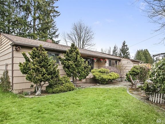 The front yard also features a pergola with pond and seating area.