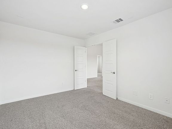 Guest bedroom in the Sabine floorplan at a Meritage Homes community.