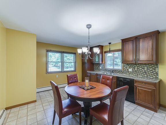 The quartz counters are a designers top choice for style and durability, the tile back splash and tile patterned flooring add the finishing touch to this spacious eat in kitchen!     