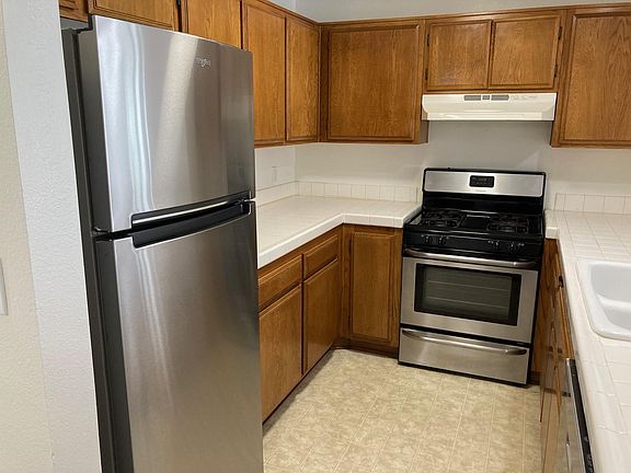 Full size brand new stainless steel refrigerator plus a stainless steel gas stove and oven