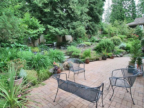 Terraced, secluded backyard garden and hot tub